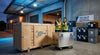 A large branded exhibit shipping crate sits on a loading dock surrounded by neatly stacked display cases, conveying professional trade show freight logistics.