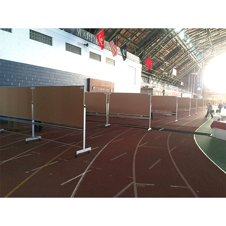 Indoor athletic track with hurdles and flags on a building exterior